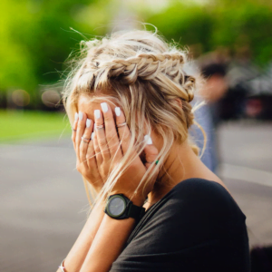 woman holding her head in pain headache