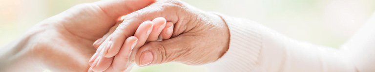 elderly couple holding hands close up