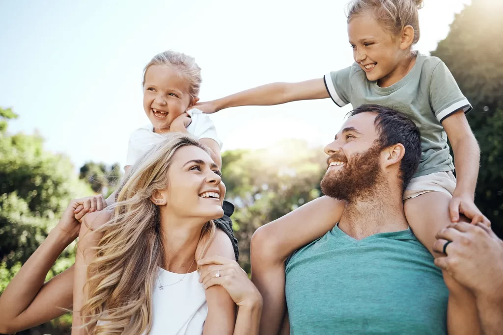 Young happy family outside in the sunshine